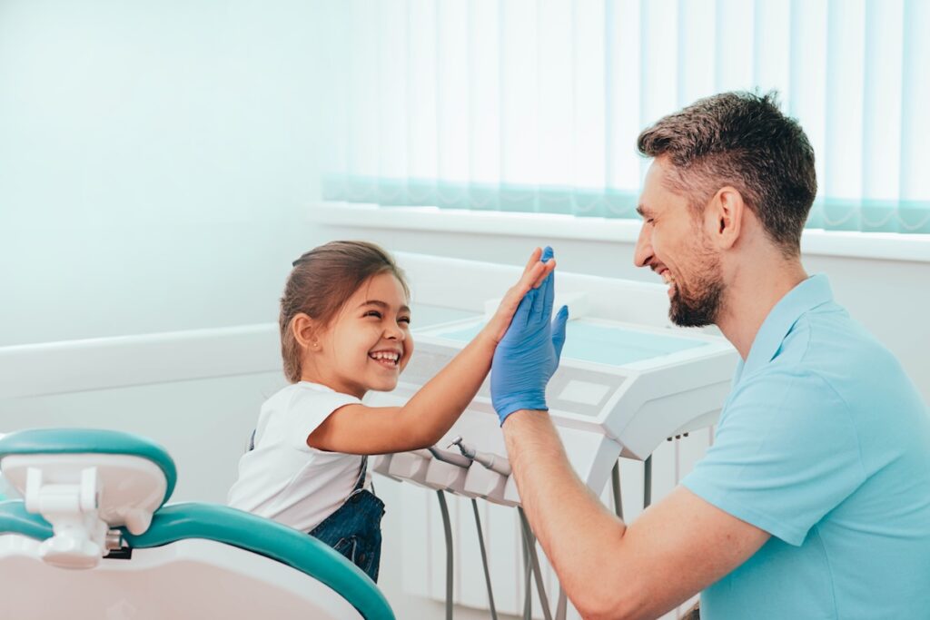 Child at the dentist high five